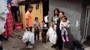 Family with groceries outside their home.