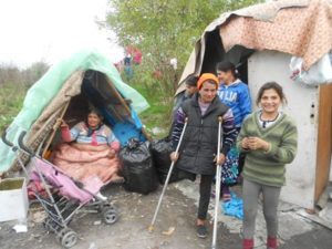 Women and children in front of tents.