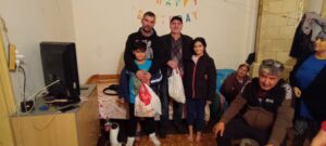 A group of people standing in front of a birthday sign.