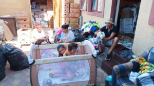 A group of people sitting on the steps outside.