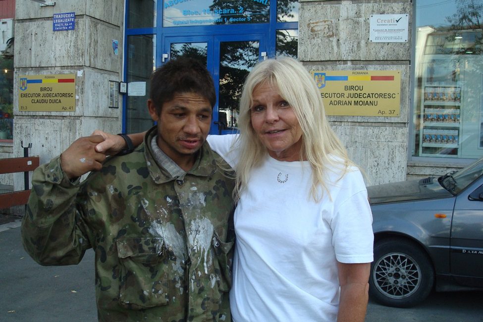 A woman and a young man posing for the camera.