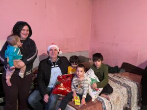 Family gathering with gifts in cozy room.