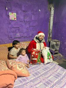Santa Claus with children in a room.