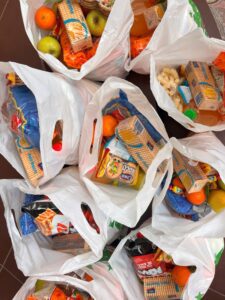 Grocery bags filled with various food items.