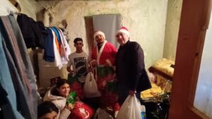 People delivering gifts in a small room.